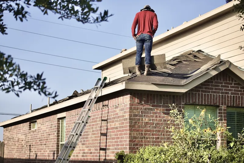 Professional roofer working on a residential roof in Timbercrest at Lakeville